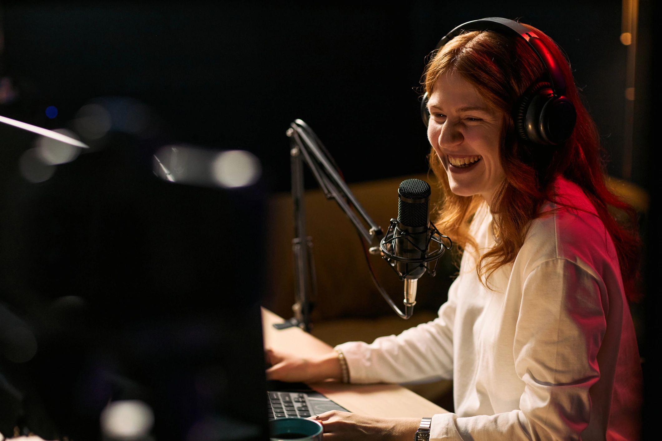 Radio host speaking into a microphone during a live broadcast