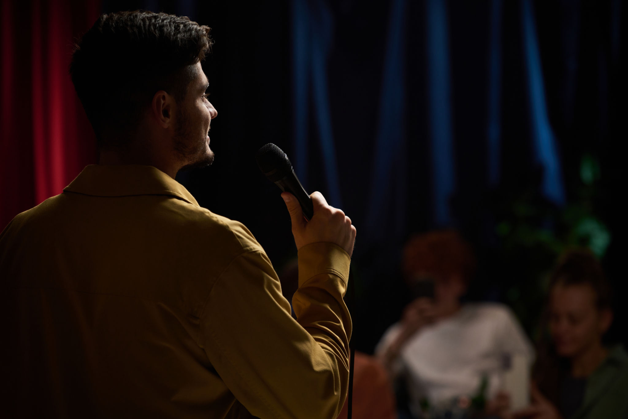 Host speaking to an audience during a live event